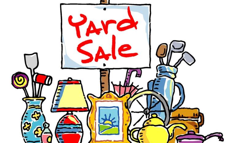 yard sale sign in front of household items